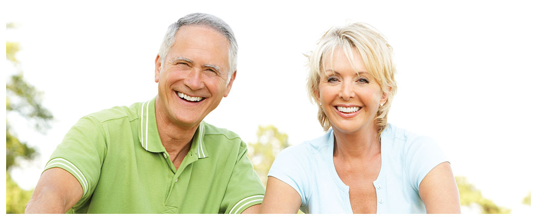 Smiling couple outdoors on a sunny day.
