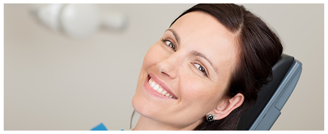 Smiling person in a dental chair.