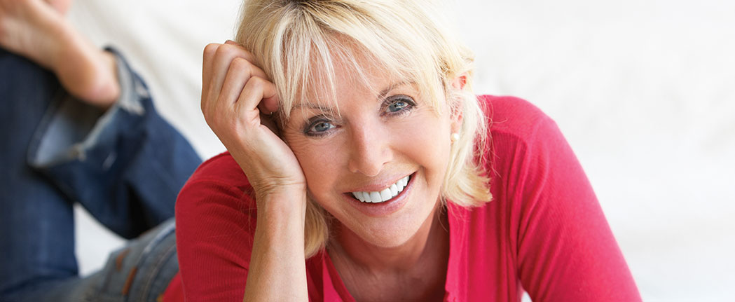 Smiling woman lying on the floor.