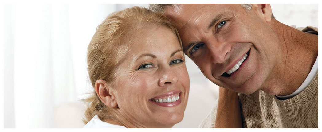 Smiling couple posing closely together indoors.