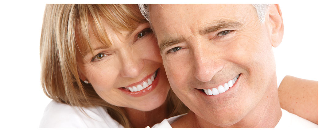 Smiling couple embracing, close-up portrait.